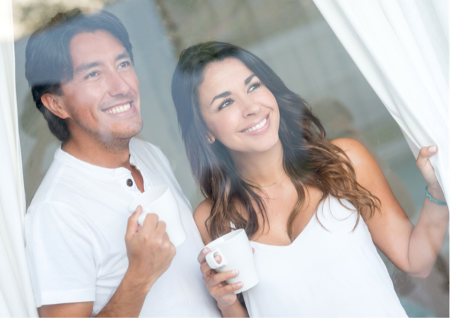 Happy couple saving money drinking coffee